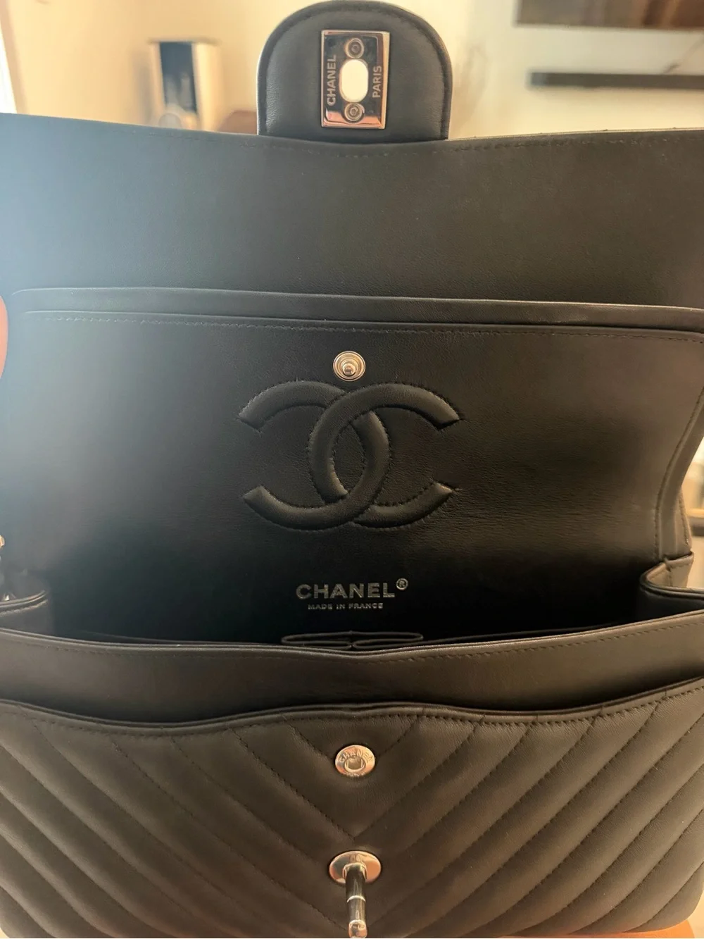 CHANEL Black Leather Interior with Silver Logo Plaque